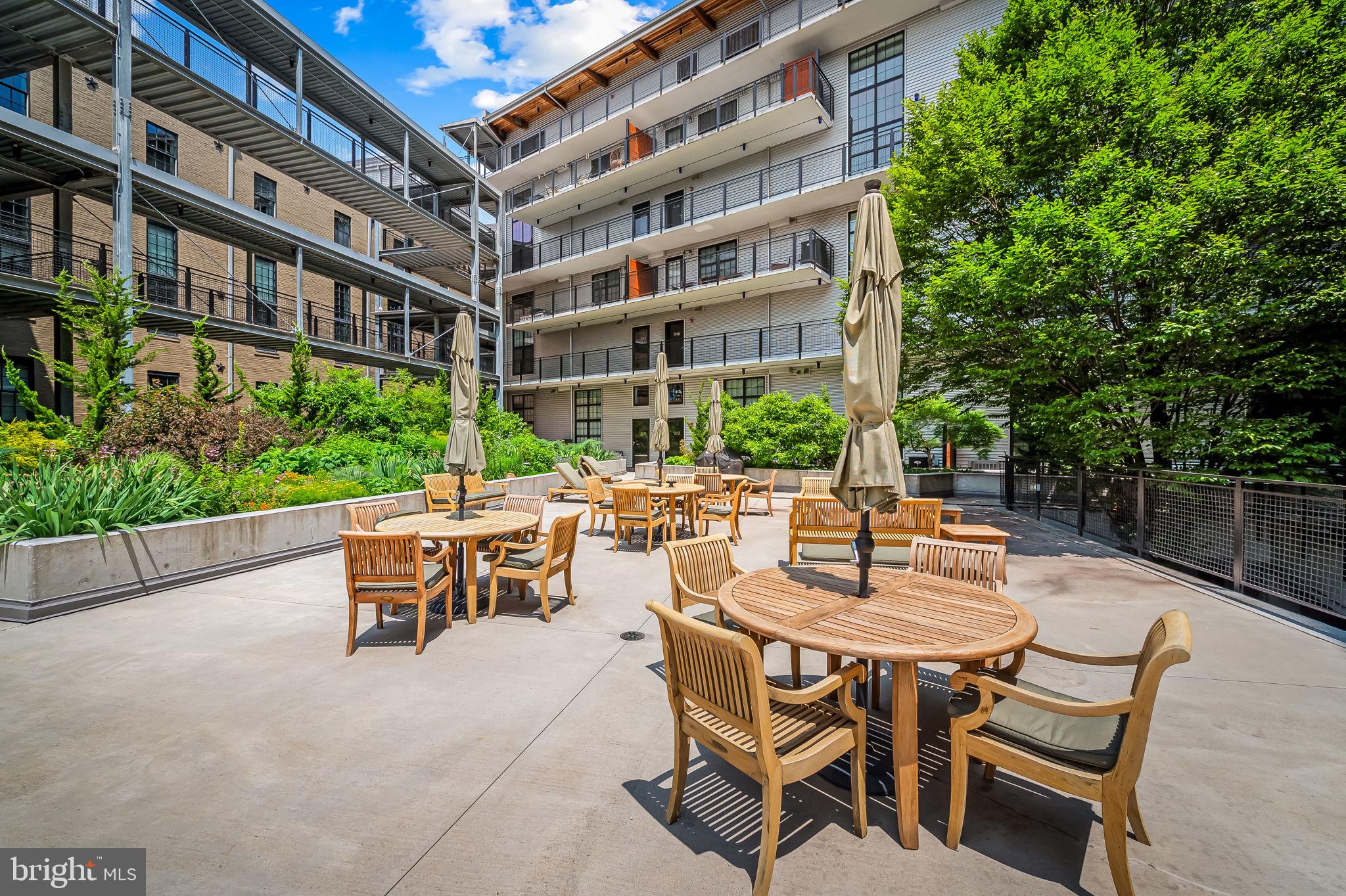 1220 Bank Street, Unit 304 Baltimore, MD 21202 - Photo 77 of 81 a view of a patio with a table and chairs