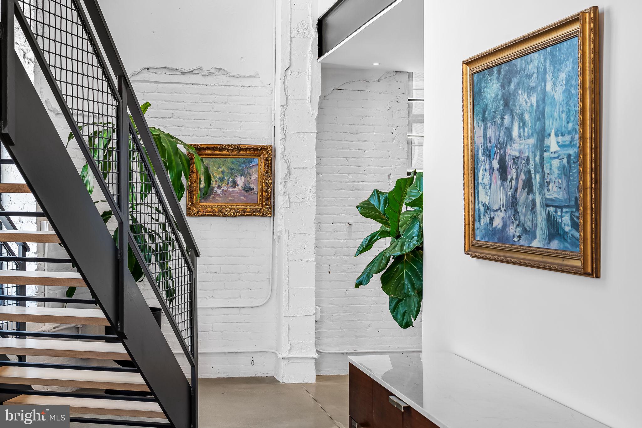 1220 Bank Street, Unit 304 Baltimore, MD 21202 - Photo 8 of 81 a view of staircase with wooden floor and a potted plant