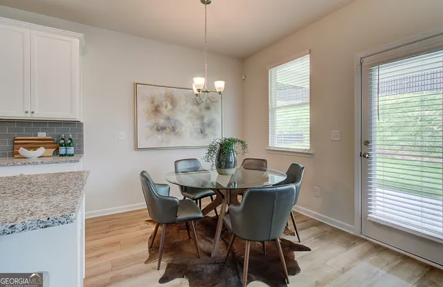 a dining room with furniture and window