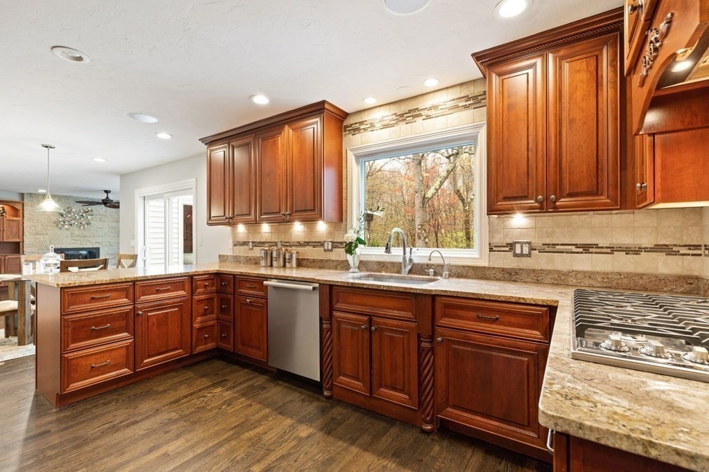 7 Kings Road Sharon, MA 02067 - Photo 13 of 41 a kitchen with stainless steel appliances granite countertop wooden cabinets a sink and dishwasher with wooden floor