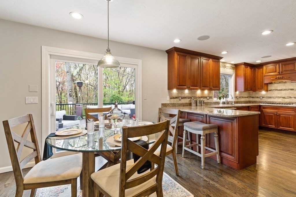 7 Kings Road Sharon, MA 02067 - Photo 16 of 41 a dining room with stainless steel appliances granite countertop a stove top oven a dining table and chairs