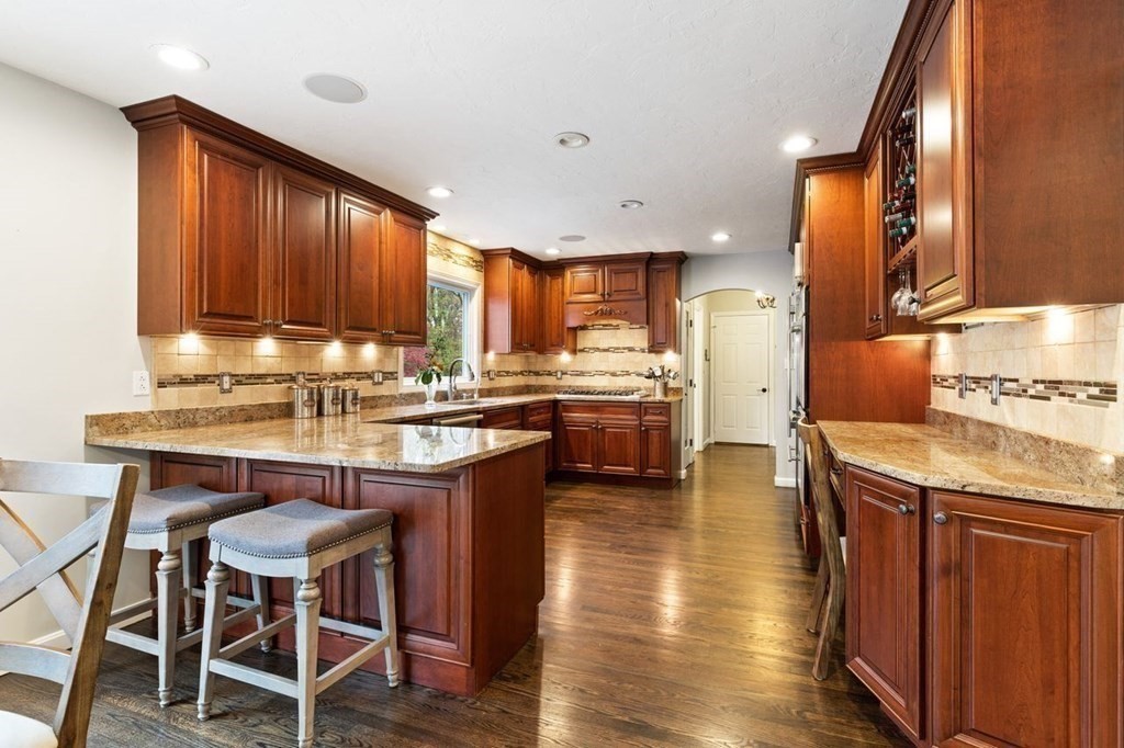 7 Kings Road Sharon, MA 02067 - Photo 17 of 41 a kitchen with stainless steel appliances granite countertop wooden cabinets a stove top oven a sink and dishwasher