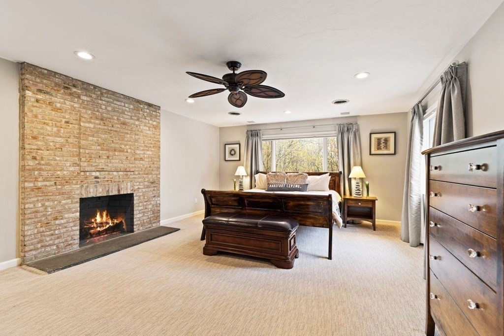 7 Kings Road Sharon, MA 02067 - Photo 25 of 41 a living room with furniture and a fireplace