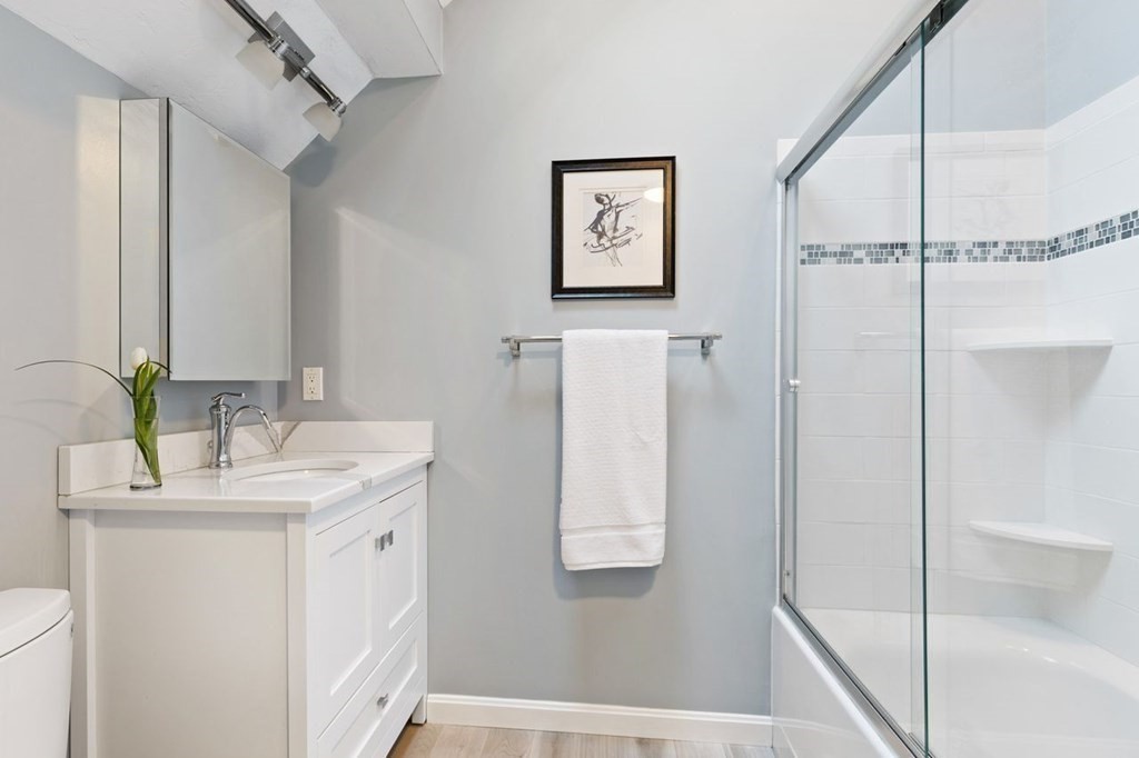 7 Kings Road Sharon, MA 02067 - Photo 31 of 41 a bathroom with a granite countertop sink a mirror a shower and a shower