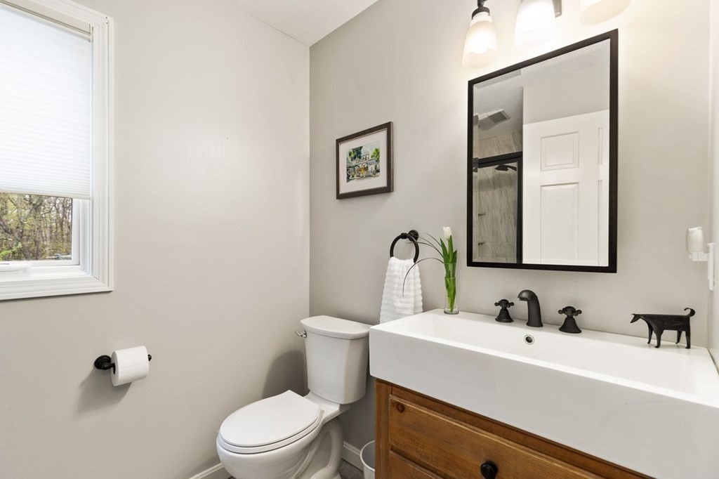 7 Kings Road Sharon, MA 02067 - Photo 32 of 41 a bathroom with a sink a toilet and mirror