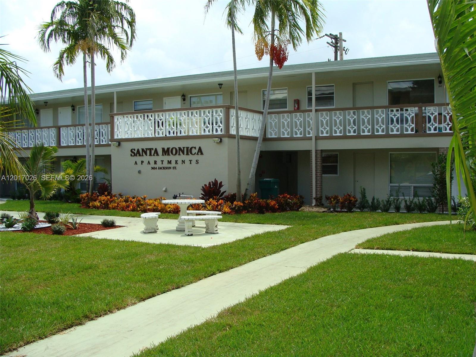 3624 Jackson Street, Unit 2 Hollywood, FL 33021 - Photo 4 of 10 a front view of house with yard and outdoor seating