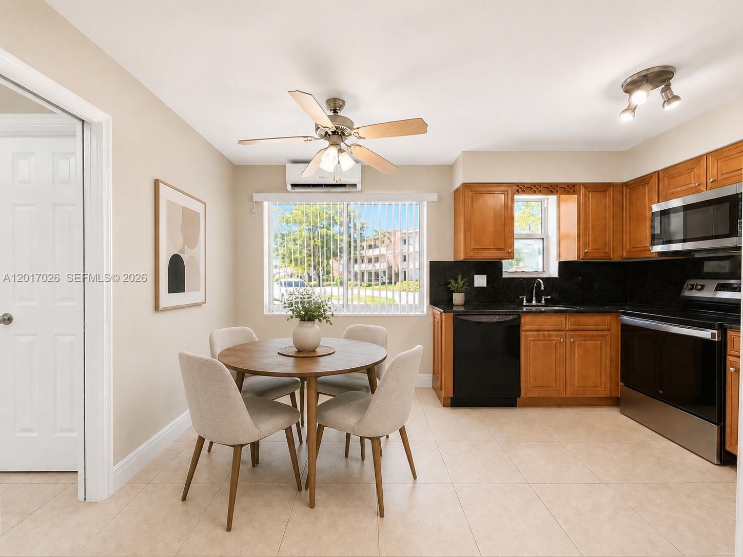 3624 Jackson Street, Unit 2 Hollywood, FL 33021 - Photo 5 of 10 a kitchen with a dining table chairs and refrigerator
