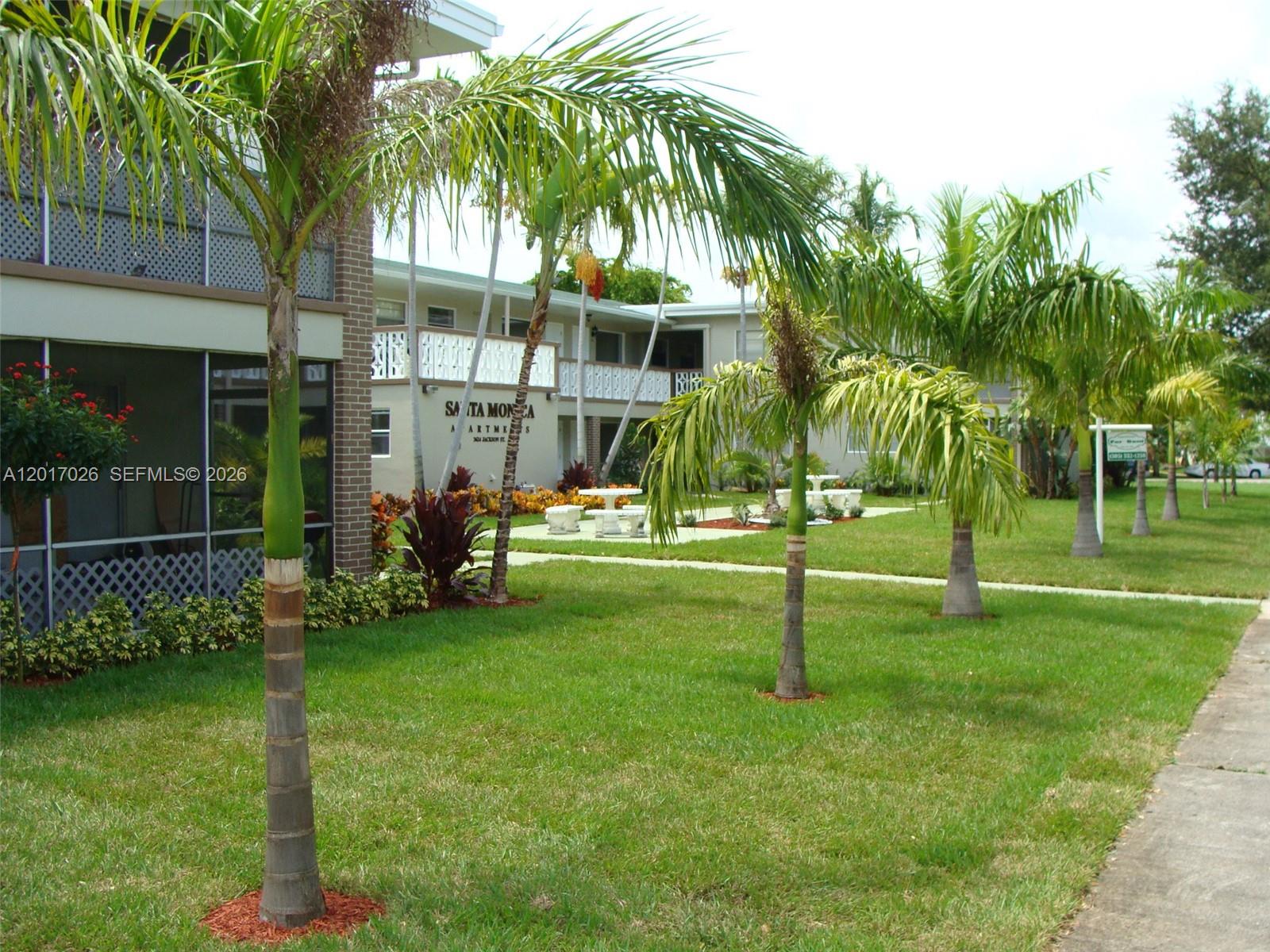 3624 Jackson Street, Unit 2 Hollywood, FL 33021 - Photo 10 of 10 a view of a house with a yard and palm trees