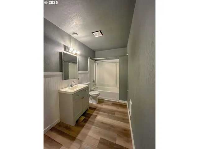 a bathroom with a sink a toilet and mirror