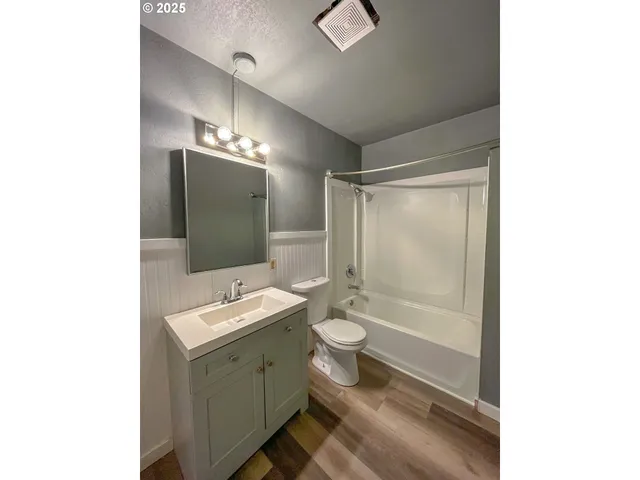 a bathroom with a sink a mirror and a toilet