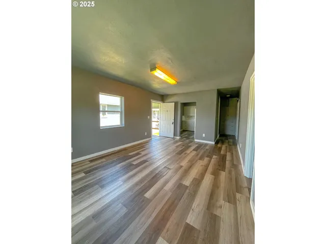 a view of room with window and wooden floor
