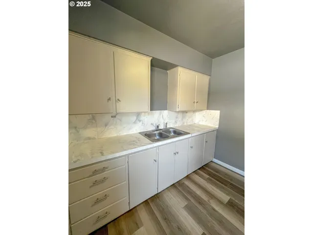 a view of a bathroom with a sink and a mirror