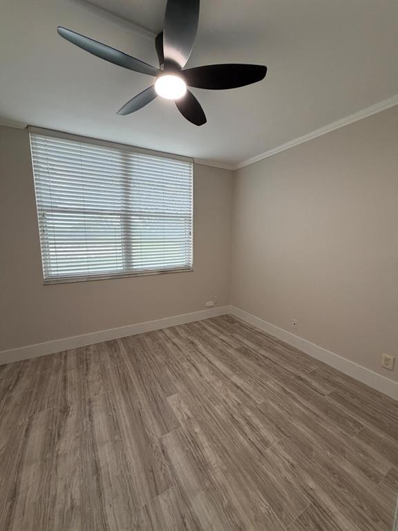 6300 Northwest 2nd Avenue, Unit 206 Boca Raton, FL 33487 - Photo 12 of 16 an empty room with wooden floor and windows