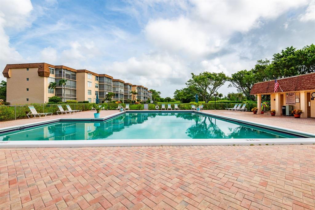6300 Northwest 2nd Avenue, Unit 206 Boca Raton, FL 33487 - Photo 15 of 16 a view of swimming pool with outdoor seating and barbeque oven