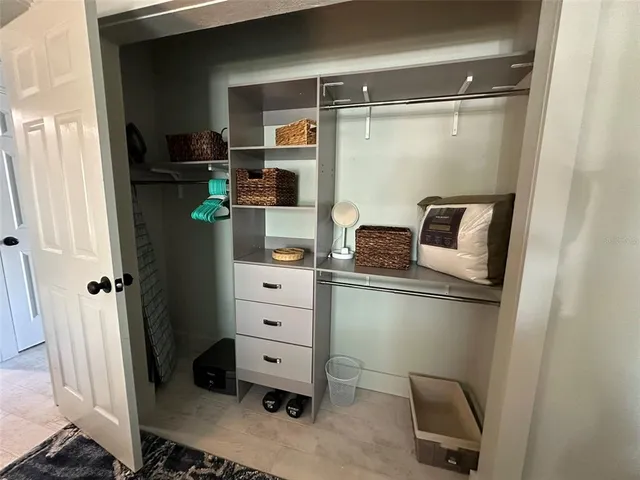 a view of a chairs and table in patio with a barbeque grill