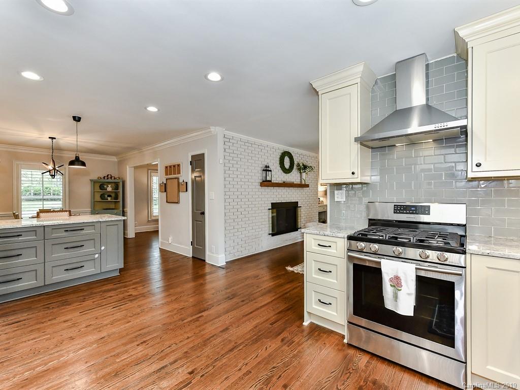 3110 Ferncliff Road Charlotte, NC 28211 - Photo 12 of 41 a kitchen with wooden floors and white stainless steel appliances