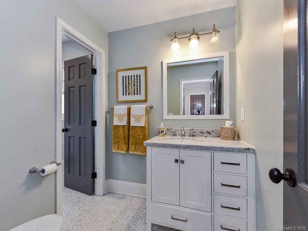 3110 Ferncliff Road Charlotte, NC 28211 - Photo 26 of 41 a bathroom with a granite countertop sink a mirror and a vanity