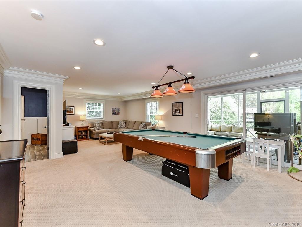 3110 Ferncliff Road Charlotte, NC 28211 - Photo 29 of 41 a large kitchen with stainless steel appliances a stove a sink dishwasher and a dining table with the living room view