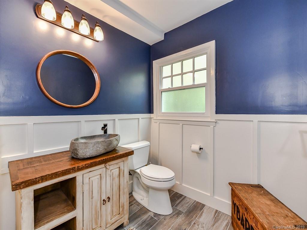 3110 Ferncliff Road Charlotte, NC 28211 - Photo 34 of 41 a bathroom with a toilet a sink and a mirror