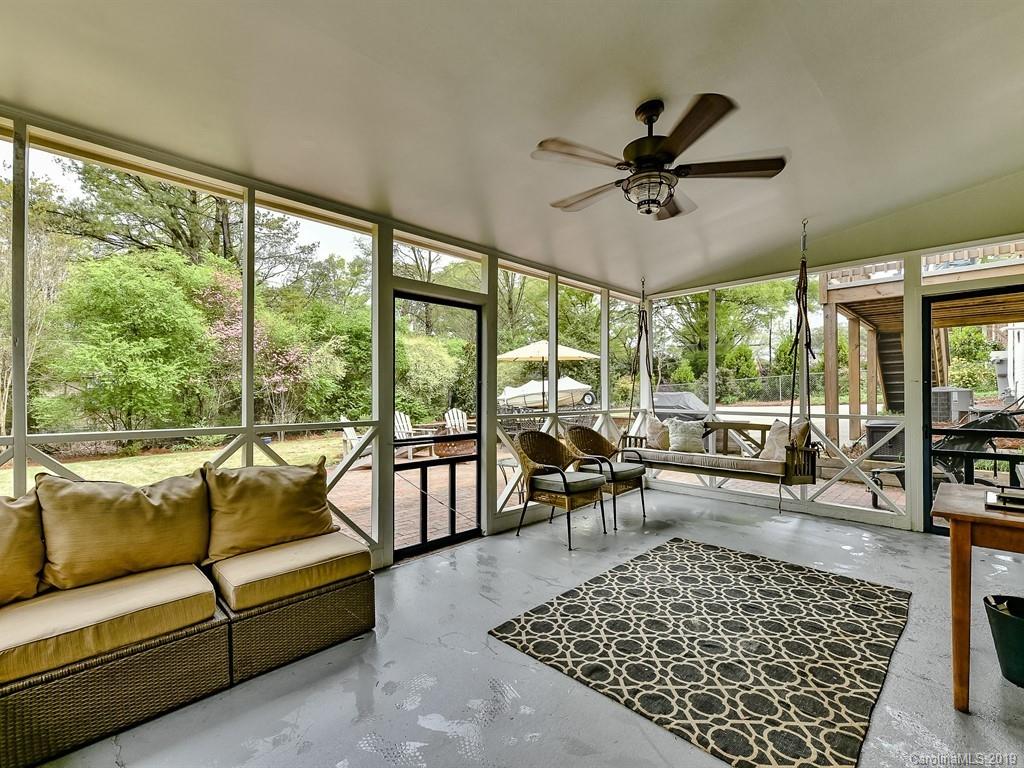 3110 Ferncliff Road Charlotte, NC 28211 - Photo 36 of 41 a living room with furniture large windows a rug and a table