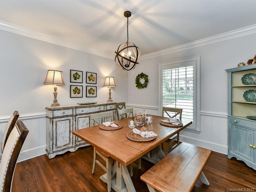 3110 Ferncliff Road Charlotte, NC 28211 - Photo 6 of 41 a view of a dining room with furniture a chandelier and wooden floor