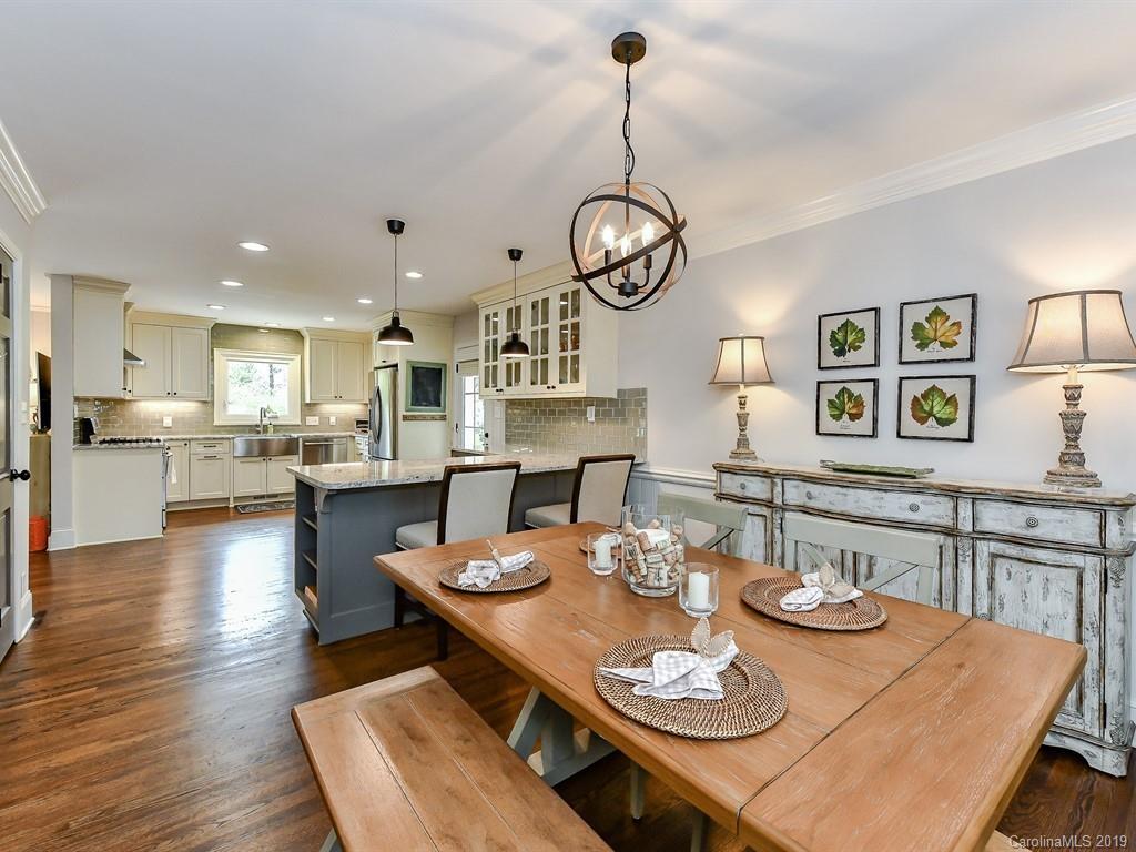 3110 Ferncliff Road Charlotte, NC 28211 - Photo 7 of 41 a open dining room with furniture a kitchen and chandelier