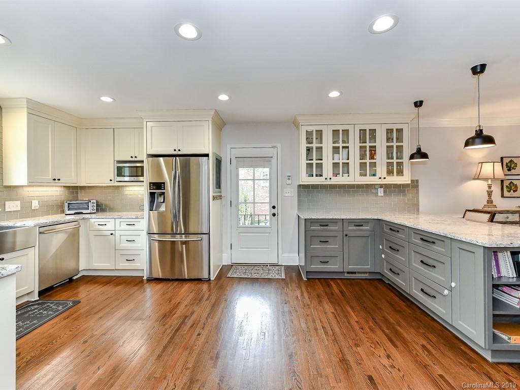 3110 Ferncliff Road Charlotte, NC 28211 - Photo 8 of 41 a kitchen with a refrigerator and white cabinets