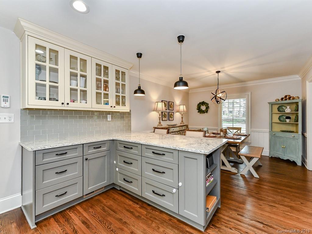 3110 Ferncliff Road Charlotte, NC 28211 - Photo 10 of 41 a kitchen with a stove a window and chairs