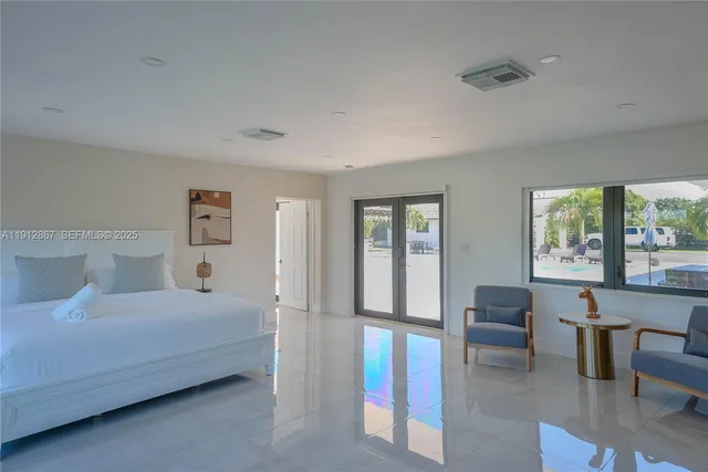 a bedroom with a bed and a large window