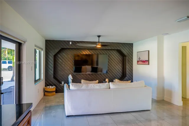 a living room with furniture and a mirror