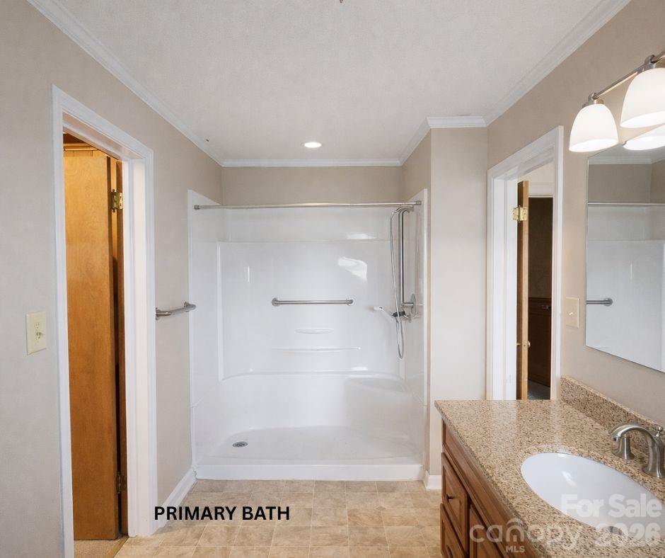 7362 Hull Road Cherryville, NC 28021 - Photo 12 of 22 a bathroom with a granite countertop sink a mirror and a shower