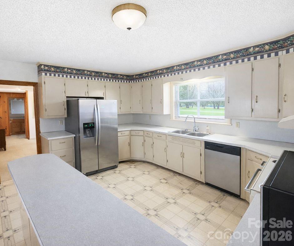7362 Hull Road Cherryville, NC 28021 - Photo 3 of 22 a kitchen with granite countertop a sink stainless steel appliances and cabinets