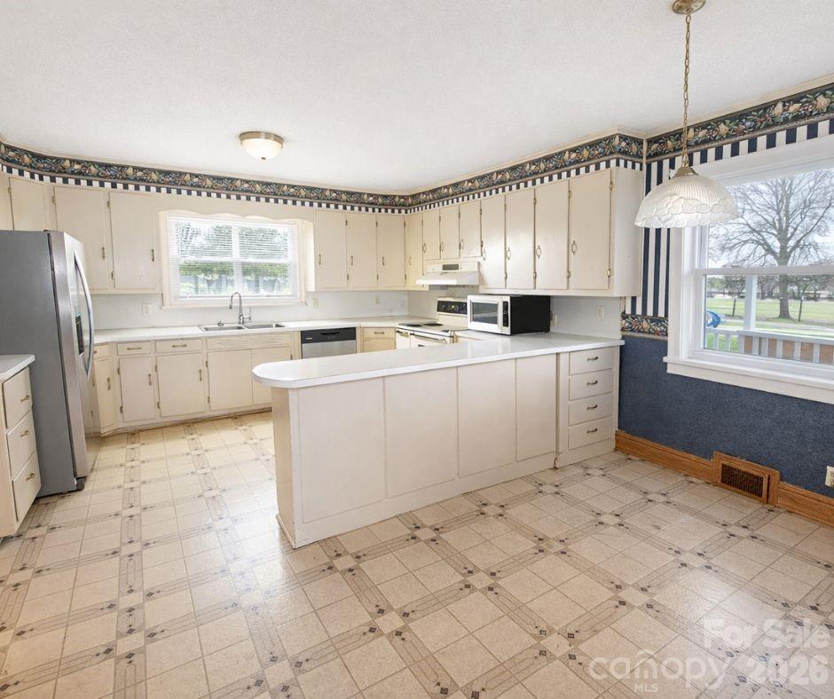 7362 Hull Road Cherryville, NC 28021 - Photo 4 of 22 a kitchen with a sink window and cabinets