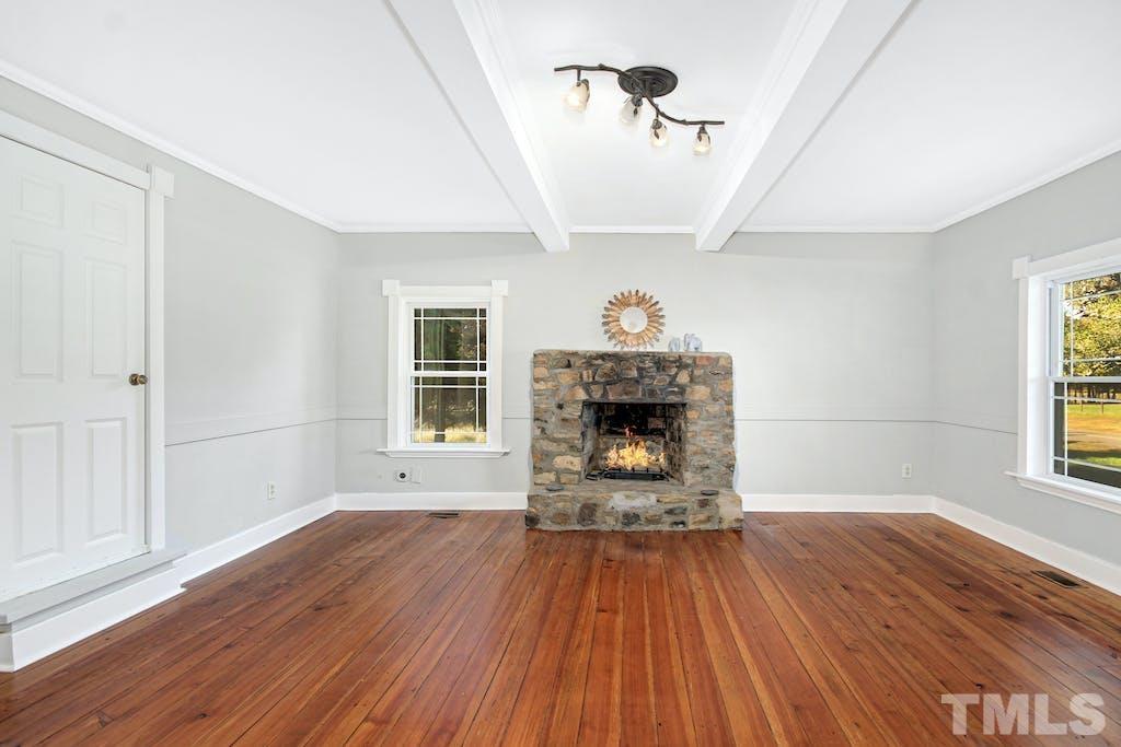 4610 Hall Road Rougemont, NC 27572 - Photo 19 of 43 a view of empty room with wooden floor and fireplace
