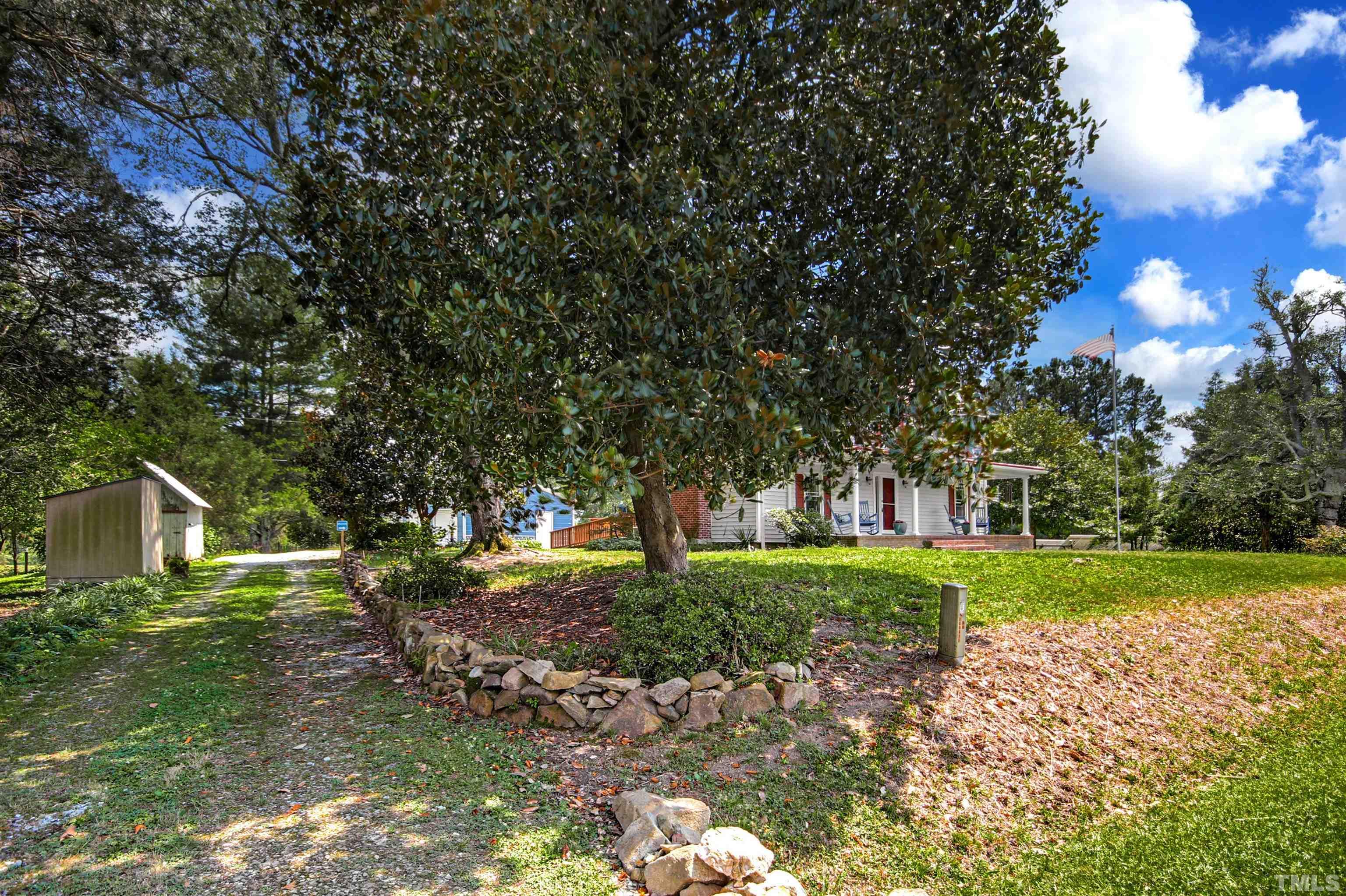 4610 Hall Road Rougemont, NC 27572 - Photo 2 of 43 a backyard of a house with plants and large trees