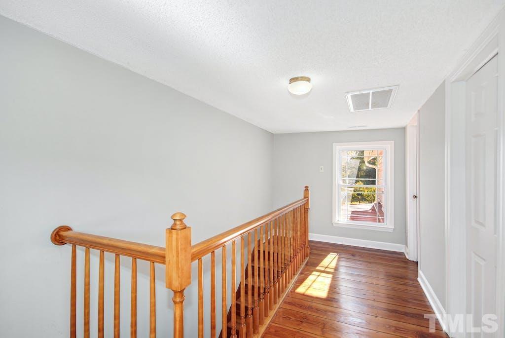 4610 Hall Road Rougemont, NC 27572 - Photo 23 of 43 a view of a hallway with wooden floor and stairs
