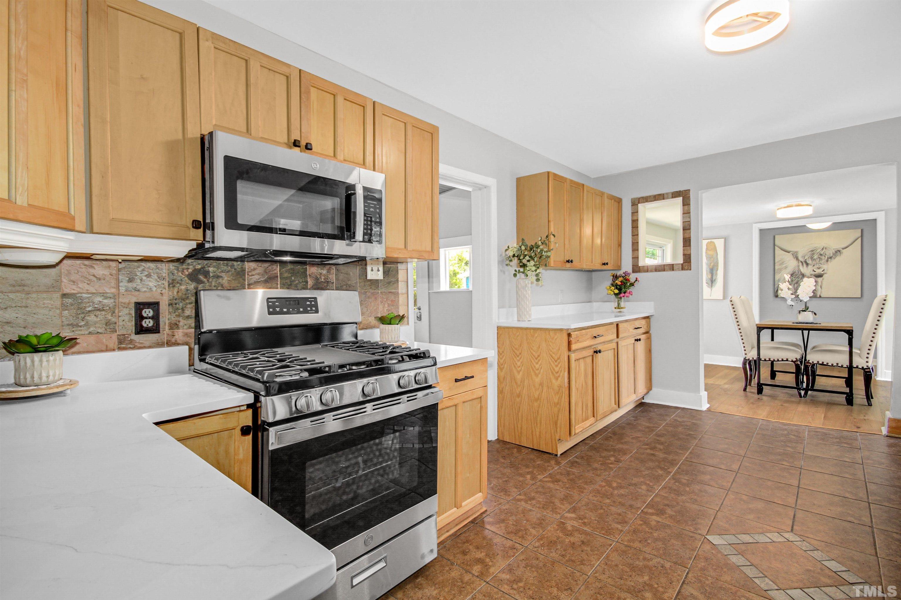 4610 Hall Road Rougemont, NC 27572 - Photo 26 of 43 a kitchen with stainless steel appliances a stove a sink and a microwave