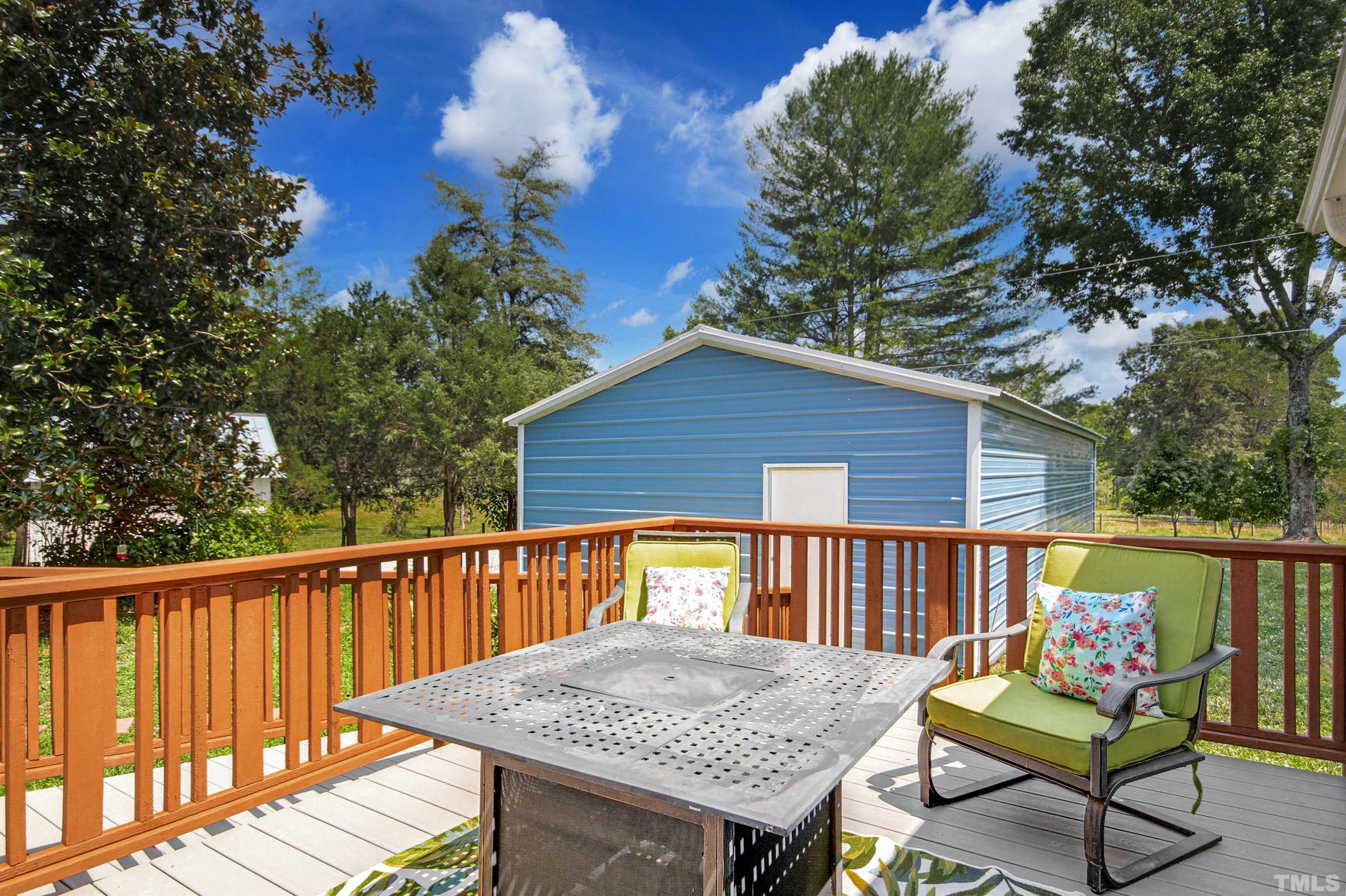 4610 Hall Road Rougemont, NC 27572 - Photo 31 of 43 a view of a wooden deck and a backyard