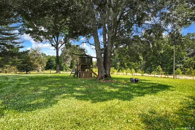 a swimming pool with trees in the background