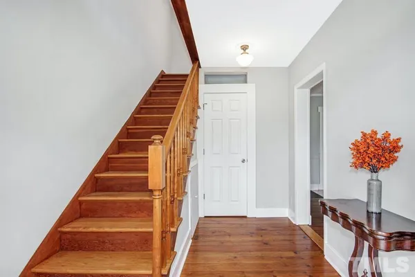 a view of an entryway with wooden floor and door