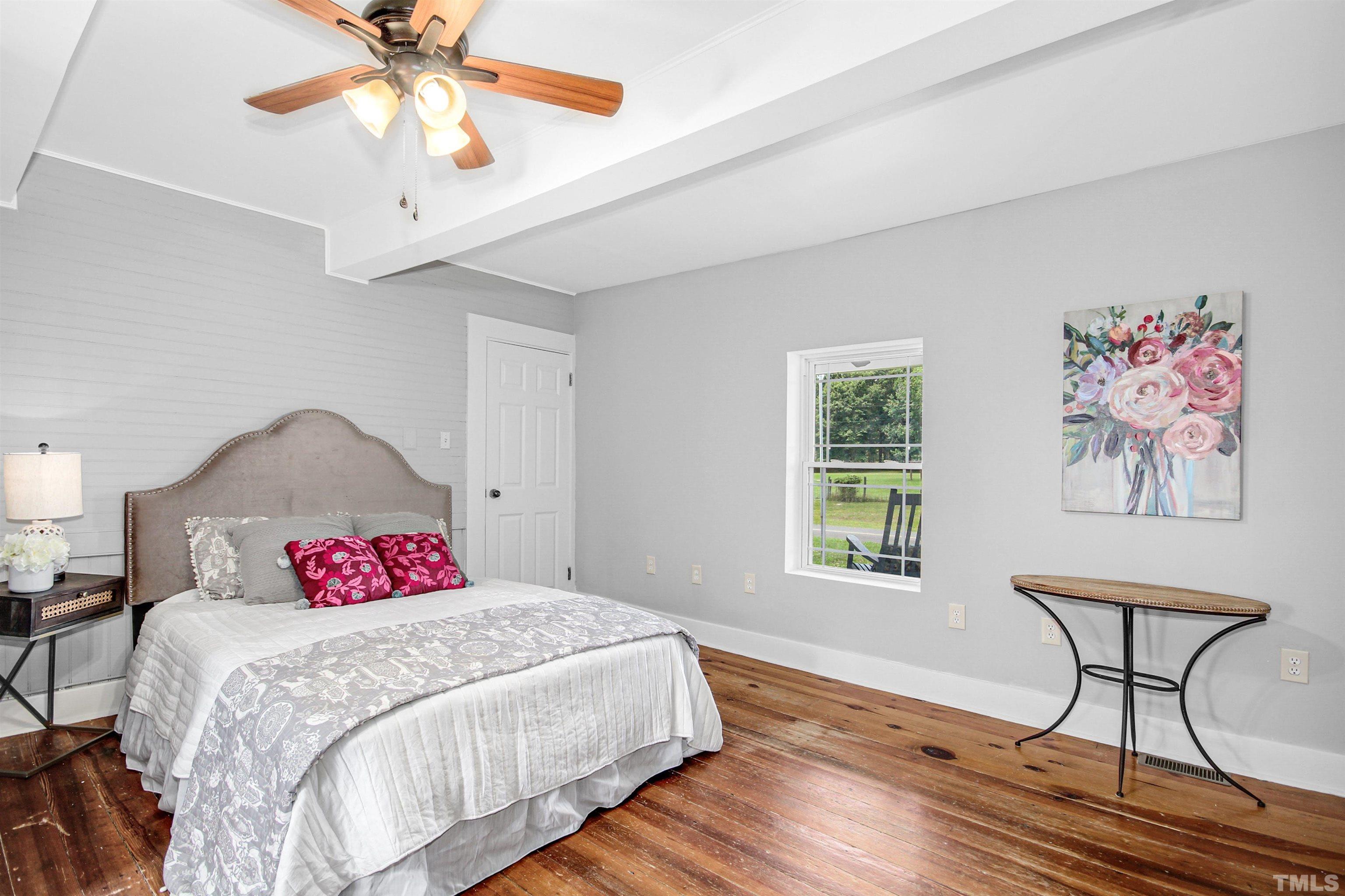 4610 Hall Road Rougemont, NC 27572 - Photo 9 of 43 a bedroom with a bed and a chandelier