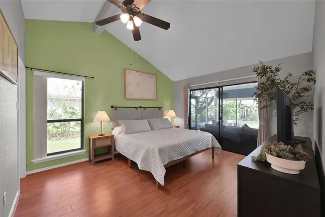 a spacious bedroom with a bed and a chandelier