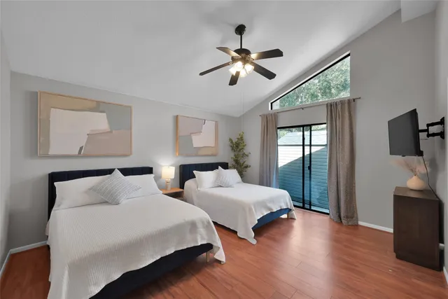 a bedroom with two beds and a chandelier