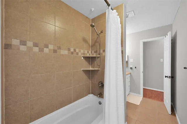 a bathroom with a bathtub and a shower