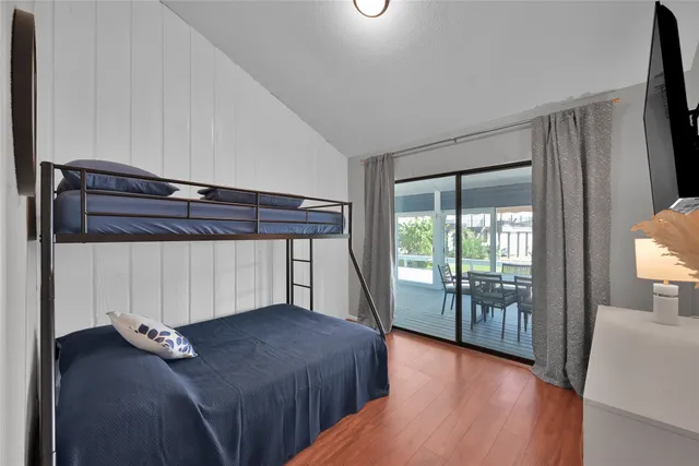 a bedroom with a bed and glass door