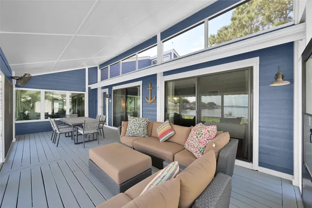 a balcony with furniture and wooden floor