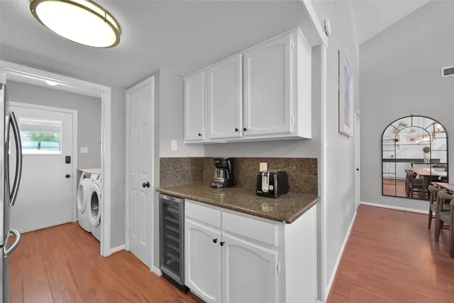 a kitchen with stainless steel appliances granite countertop a stove and a wooden floors