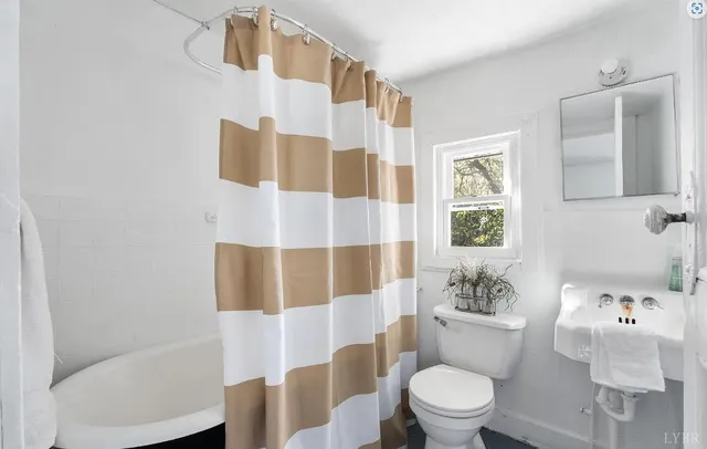 a white toilet sitting next to a bathroom sink