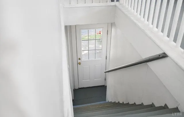 a view of a hallway view with wooden floor and staircase