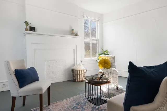 a living room with furniture and a lamp